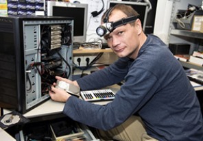 man fixing computer